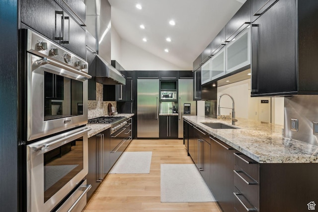 2067 E Pheasant Cir, Holladay, UT 84121 - kitchen featuring high quality appliances, a sink, light wood-style floors, lofted ceiling, and decorative backsplash