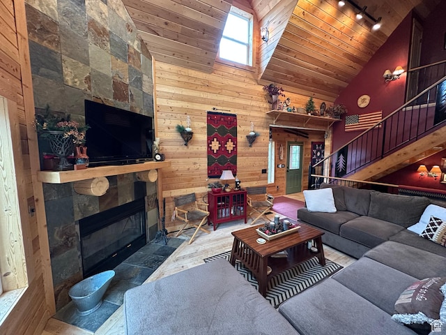 9281 N Uinta Dr Unit 348, Oakley, UT 84055 - living room featuring track lighting, wooden ceiling, high vaulted ceiling, stairs, and wood walls