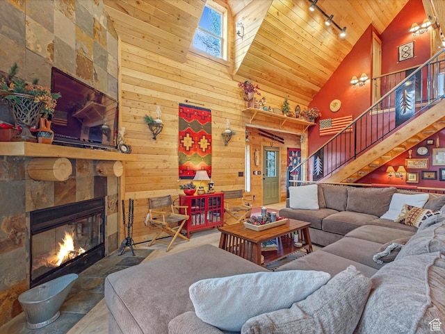 9281 N Uinta Dr, Oakley, UT 84055 - living room featuring wooden ceiling, rail lighting, high vaulted ceiling, stairway, and wood walls