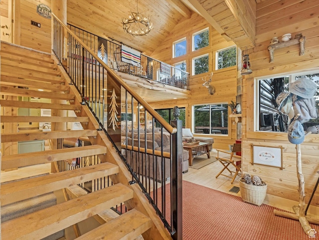 9281 N Uinta Dr, Oakley, UT 84055 - staircase with wood walls, high vaulted ceiling, wood ceiling with exposed beams, wood finished floors, and a chandelier