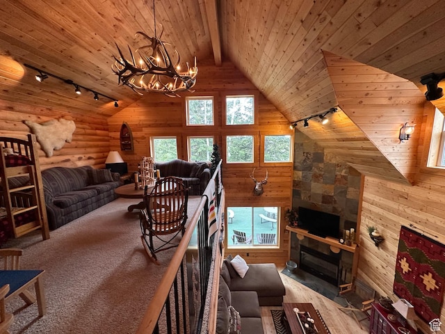 9281 N Uinta Dr Unit 348, Oakley, UT 84055 - living area with track lighting, wooden ceiling, a chandelier, wooden walls, and a fireplace