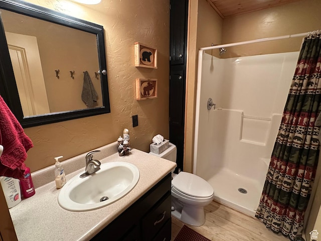 9281 N Uinta Dr Unit 348, Oakley, UT 84055 - full bathroom with a textured wall, a stall shower, vanity, toilet, and wood finished floors