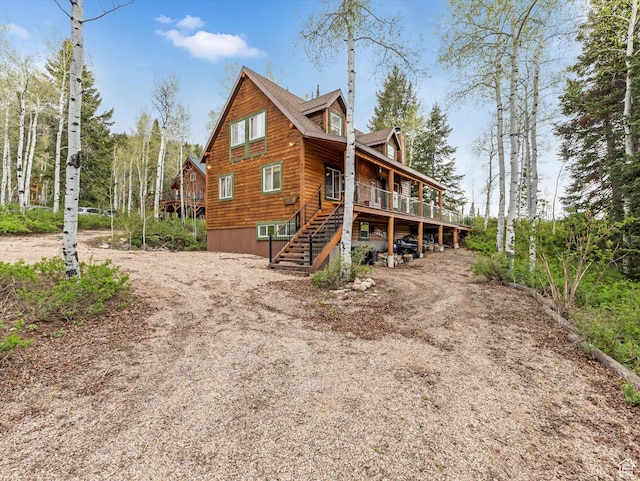 9281 N Uinta Dr, Oakley, UT 84055 - view of home's exterior featuring stairway, a wooden deck, and driveway