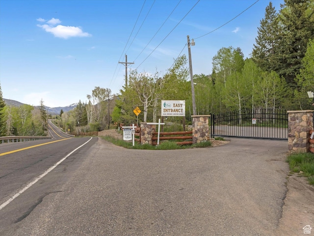 9281 N Uinta Dr, Oakley, UT 84055 - view of asphalt street featuring a gate and a mountain view