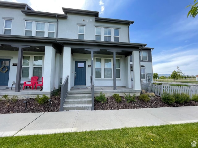 5957 W Lake Ave, South Jordan, UT 84009 - view of front facade featuring a porch and stucco siding