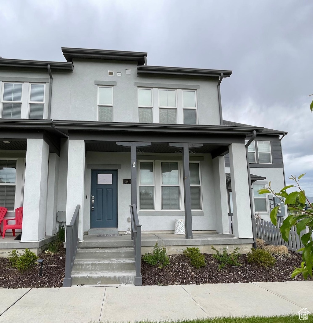 5957 W Lake Ave, South Jordan, UT 84009 - view of front of house with covered porch and stucco siding