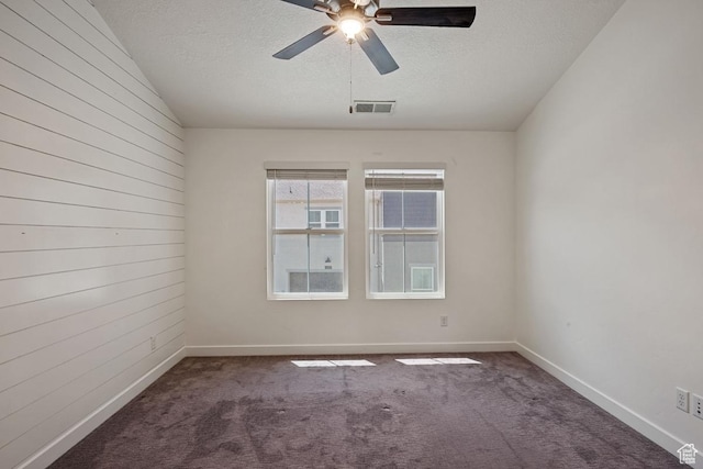5957 W Lake Ave, South Jordan, UT 84009 - carpeted empty room featuring a textured ceiling, wooden walls, a ceiling fan, and baseboards