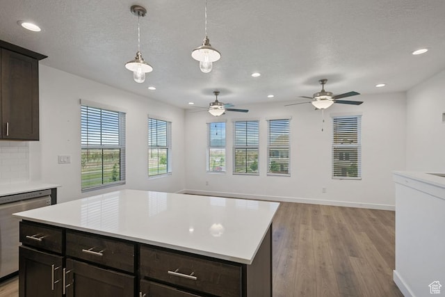 5957 W Lake Ave, South Jordan, UT 84009 - kitchen featuring stainless steel dishwasher, light wood-style flooring, light countertops, recessed lighting, and dark brown cabinets