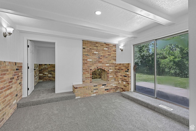 181 E 5150 S, Washington Terrace, UT 84405 - unfurnished living room with carpet floors, beam ceiling, a textured ceiling, brick wall, and a fireplace