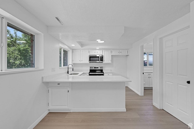 181 E 5150 S, Washington Terrace, UT 84405 - kitchen featuring stainless steel appliances, a sink, a textured ceiling, light wood-style flooring, and light countertops
