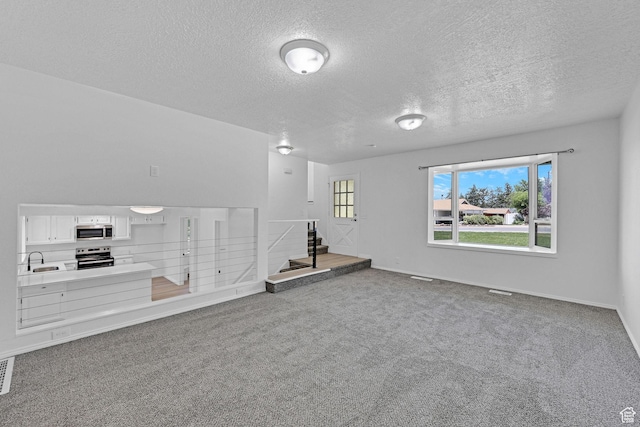 181 E 5150 S, Washington Terrace, UT 84405 - carpeted empty room featuring a sink, a textured ceiling, stairs, and baseboards