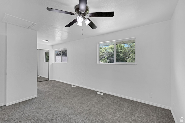 181 E 5150 S, Washington Terrace, UT 84405 - empty room with dark carpet, a textured ceiling, ceiling fan, and baseboards