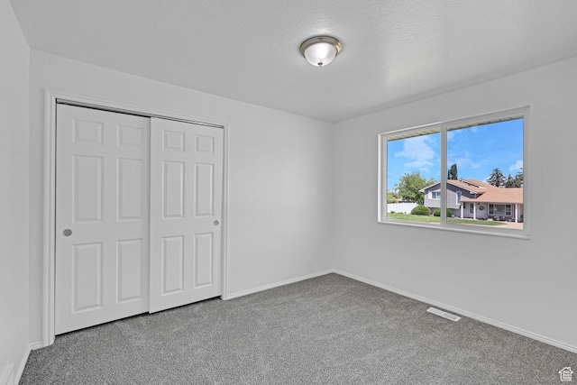 181 E 5150 S, Washington Terrace, UT 84405 - unfurnished bedroom featuring carpet flooring, baseboards, and a closet