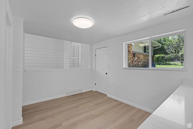 181 E 5150 S, Washington Terrace, UT 84405 - spare room with wood finished floors, a textured ceiling, and baseboards