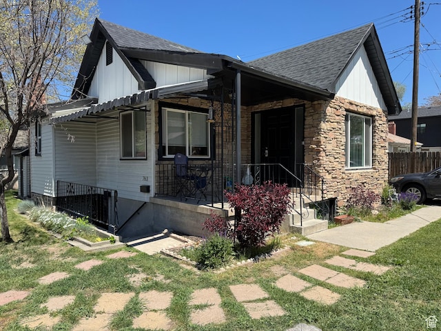 751 E Scott Ave, Millcreek, UT 84106 - view of front of home featuring board and batten siding, a shingled roof, and stone siding