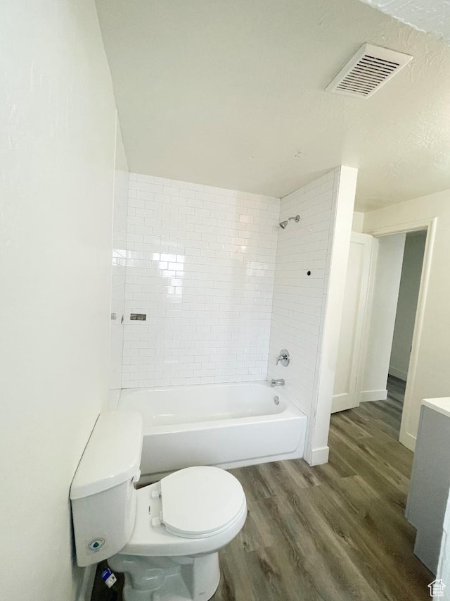 751 E Scott Ave, Millcreek, UT 84106 - bathroom featuring wood finished floors, toilet, shower / washtub combination, and baseboards