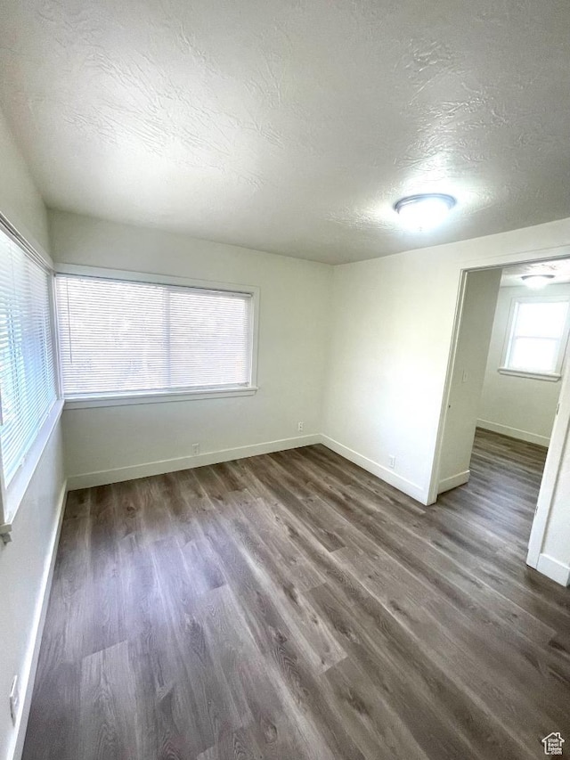 751 E Scott Ave, Millcreek, UT 84106 - empty room with a textured ceiling, baseboards, and dark wood-style floors