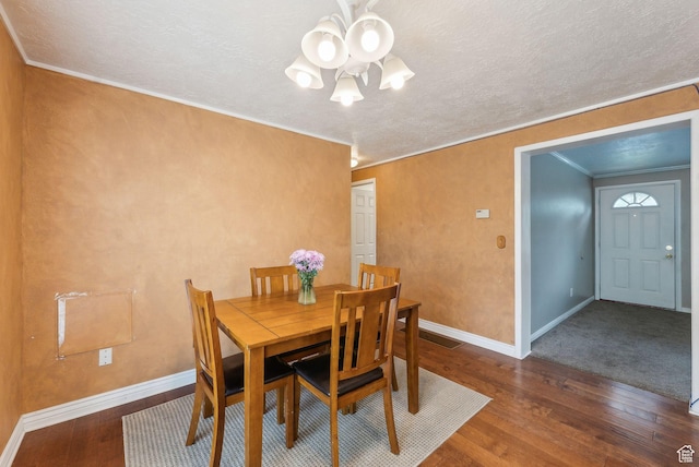 981 N Tremont St, Tremonton, UT 84337 - dining room featuring a chandelier, wood-type flooring, baseboards, crown molding, and a textured ceiling