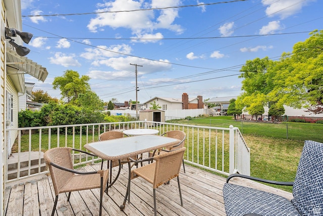 981 N Tremont St, Tremonton, UT 84337 - wooden deck featuring outdoor dining space and a lawn