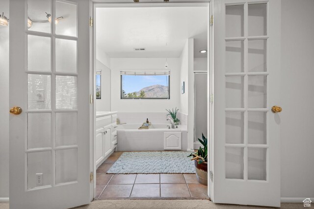 8848 S Willow Hills Ct, Sandy, UT 84093 - bathroom featuring vanity, a garden tub, tile patterned flooring, and a shower