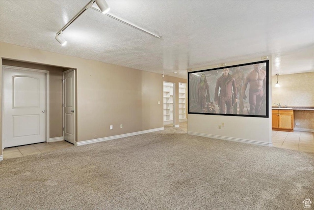 3524 N 3000 W, Farr West, UT 84404 - empty room featuring light colored carpet, a textured ceiling, baseboards, rail lighting, and light tile patterned floors