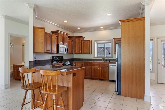 3524 N 3000 W, Farr West, UT 84404 - kitchen featuring stainless steel appliances, a peninsula, a sink, a kitchen bar, and light tile patterned floors