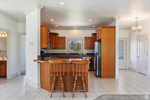 3524 N 3000 W, Farr West, UT 84404 - kitchen with appliances with stainless steel finishes, a peninsula, dark countertops, a kitchen bar, and crown molding
