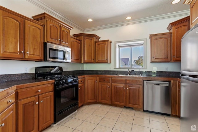 3524 N 3000 W, Farr West, UT 84404 - kitchen with stainless steel appliances, a sink, crown molding, brown cabinetry, and dark countertops