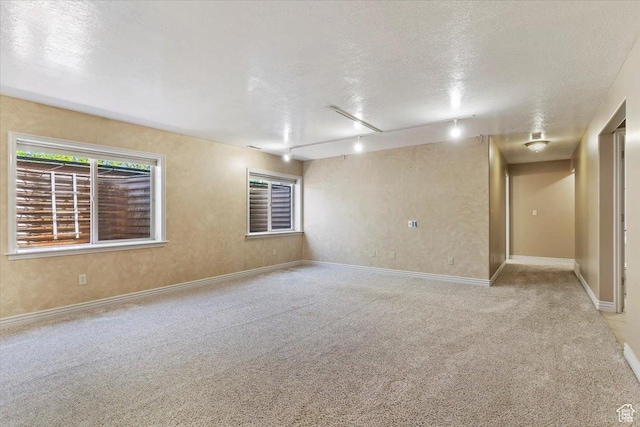 3524 N 3000 W, Farr West, UT 84404 - carpeted empty room with track lighting, a textured ceiling, and baseboards