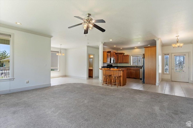 3524 N 3000 W, Farr West, UT 84404 - unfurnished living room featuring a chandelier, light colored carpet, plenty of natural light, a ceiling fan, and ornamental molding