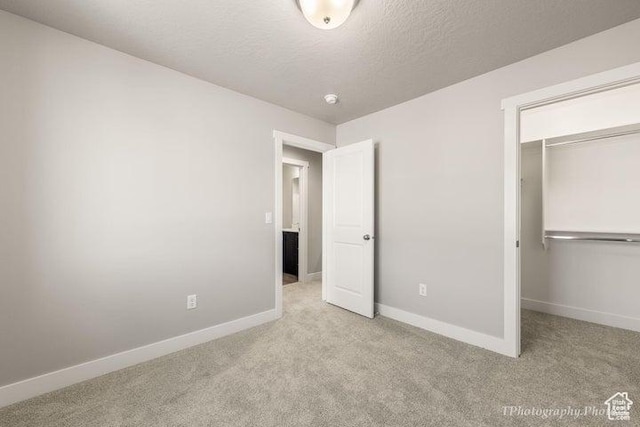 535 W 2530 N Unit 6-10, Cedar City, UT 84721 - unfurnished bedroom with carpet flooring, baseboards, a closet, a textured ceiling, and a spacious closet