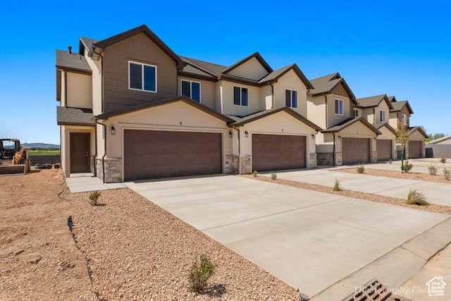 535 W 2530 N Unit 6-10, Cedar City, UT 84721 - view of front of property with stone siding, a garage, driveway, and a residential view