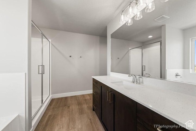 535 W 2530 N Unit 6-10, Cedar City, UT 84721 - full bathroom featuring a stall shower, vanity, wood finished floors, and baseboards