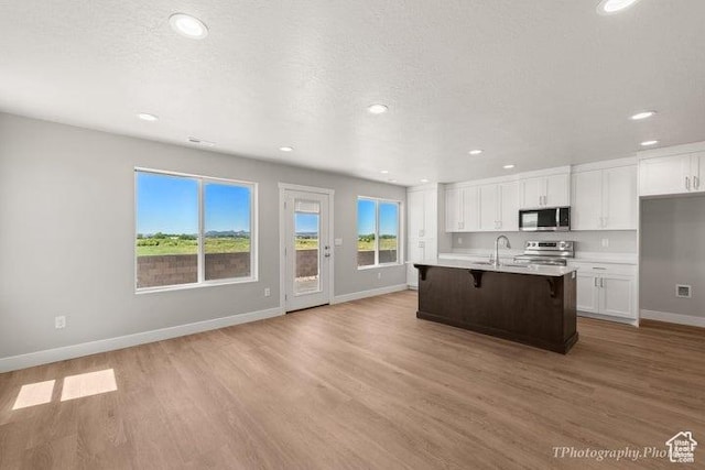 535 W 2530 N Unit 6-10, Cedar City, UT 84721 - kitchen featuring appliances with stainless steel finishes, baseboards, white cabinetry, light wood-style floors, and recessed lighting