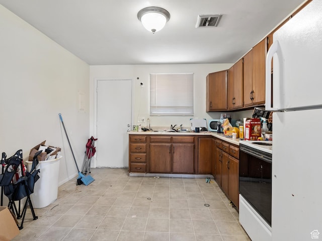 285 N 300 W, Orem, UT 84057 - kitchen with white appliances, brown cabinetry, light countertops, and light tile patterned floors