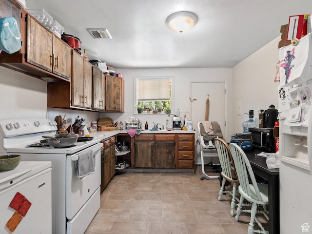 285 N 300 W, Orem, UT 84057 - kitchen featuring white appliances, light countertops, a desk, and stone finish flooring