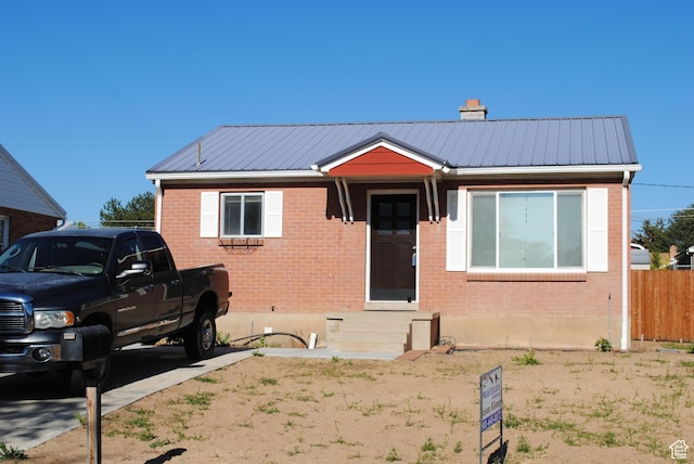 5890 S 2625 W, Roy, UT 84067 - view of front facade featuring brick siding, metal roof, entry steps, and a chimney