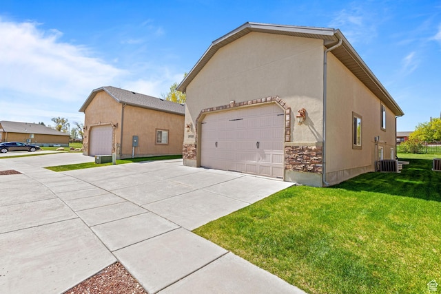 2029 S Cottage Ln, Garden City, UT 84028 - view of side of property featuring concrete driveway, a lawn, and stucco siding