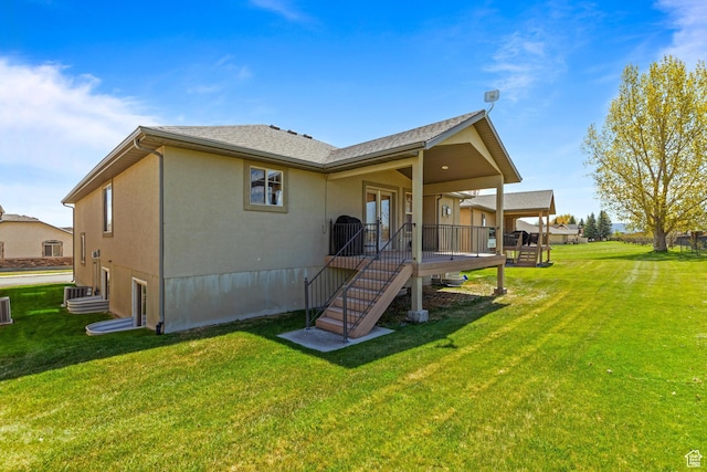 2029 S Cottage Ln, Garden City, UT 84028 - back of property featuring a yard, stucco siding, a wooden deck, and cooling unit