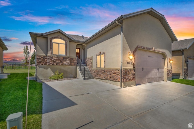 2029 S Cottage Ln, Garden City, UT 84028 - view of front of property featuring stone siding, driveway, stucco siding, and an attached garage