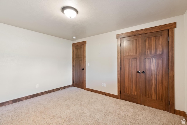 2029 S Cottage Ln, Garden City, UT 84028 - unfurnished bedroom featuring carpet, baseboards, and a closet