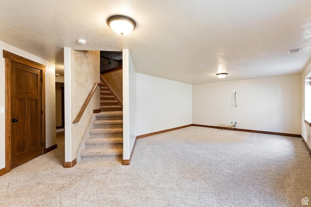 2029 S Cottage Ln, Garden City, UT 84028 - finished below grade area with carpet, baseboards, and stairs