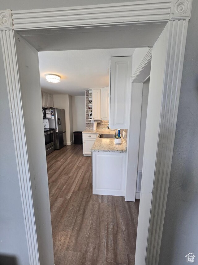 1191 N Geneva Rd, Provo, UT 84601 - kitchen with appliances with stainless steel finishes, dark wood-type flooring, white cabinetry, baseboards, and light stone counters