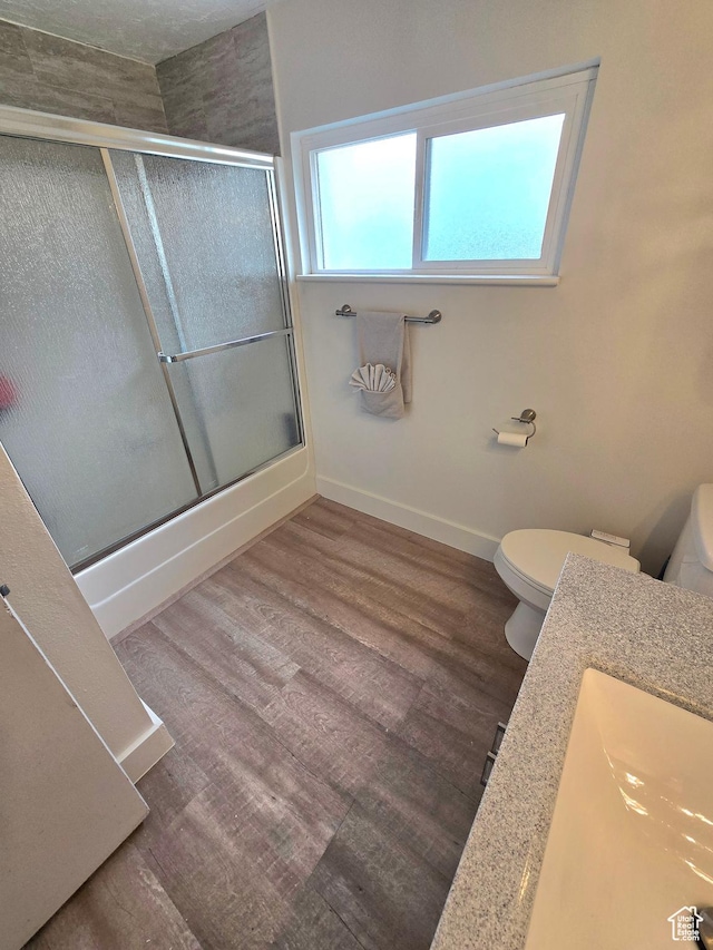 1191 N Geneva Rd, Provo, UT 84601 - bathroom featuring toilet, an enclosed shower, wood finished floors, and baseboards