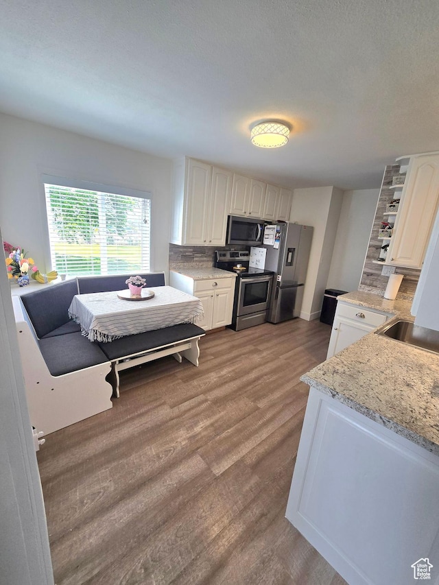1191 N Geneva Rd, Provo, UT 84601 - kitchen featuring appliances with stainless steel finishes, decorative backsplash, open shelves, and white cabinets