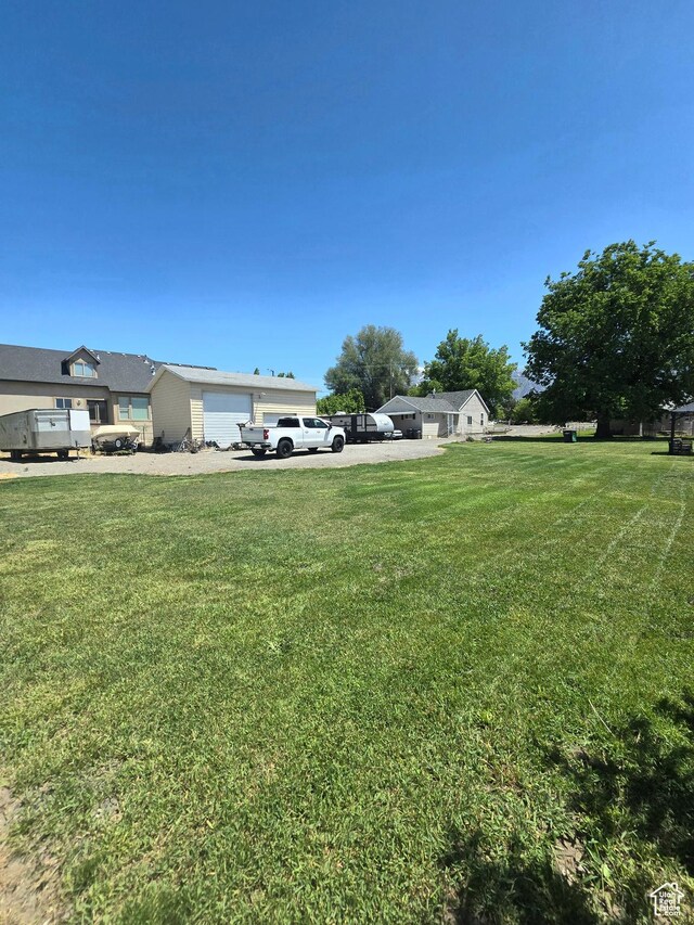 1191 N Geneva Rd, Provo, UT 84601 - view of green lawn with an attached garage and driveway