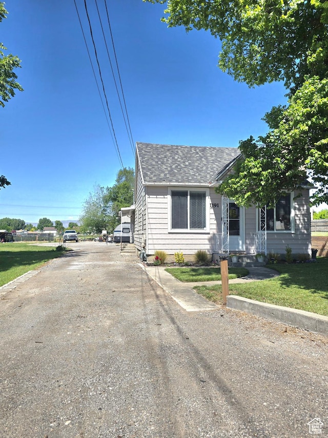1191 N Geneva Rd, Provo, UT 84601 - bungalow-style house with roof with shingles, a front lawn, and driveway