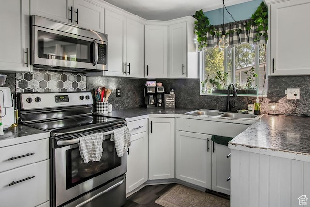 3631 W 7910 S, West Jordan, UT 84088 - kitchen featuring appliances with stainless steel finishes, a sink, backsplash, white cabinetry, and dark countertops