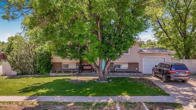 3631 W 7910 S, West Jordan, UT 84088 - view of front of house with brick siding, an attached garage, and driveway