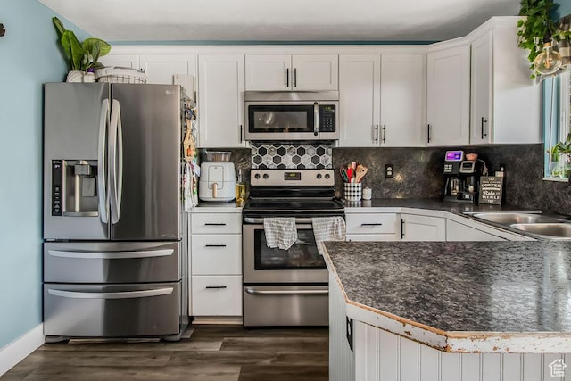 3631 W 7910 S, West Jordan, UT 84088 - kitchen with appliances with stainless steel finishes, white cabinets, dark wood-style flooring, and dark countertops